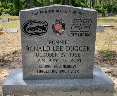 gray granite gravestone with gator and race car emblems